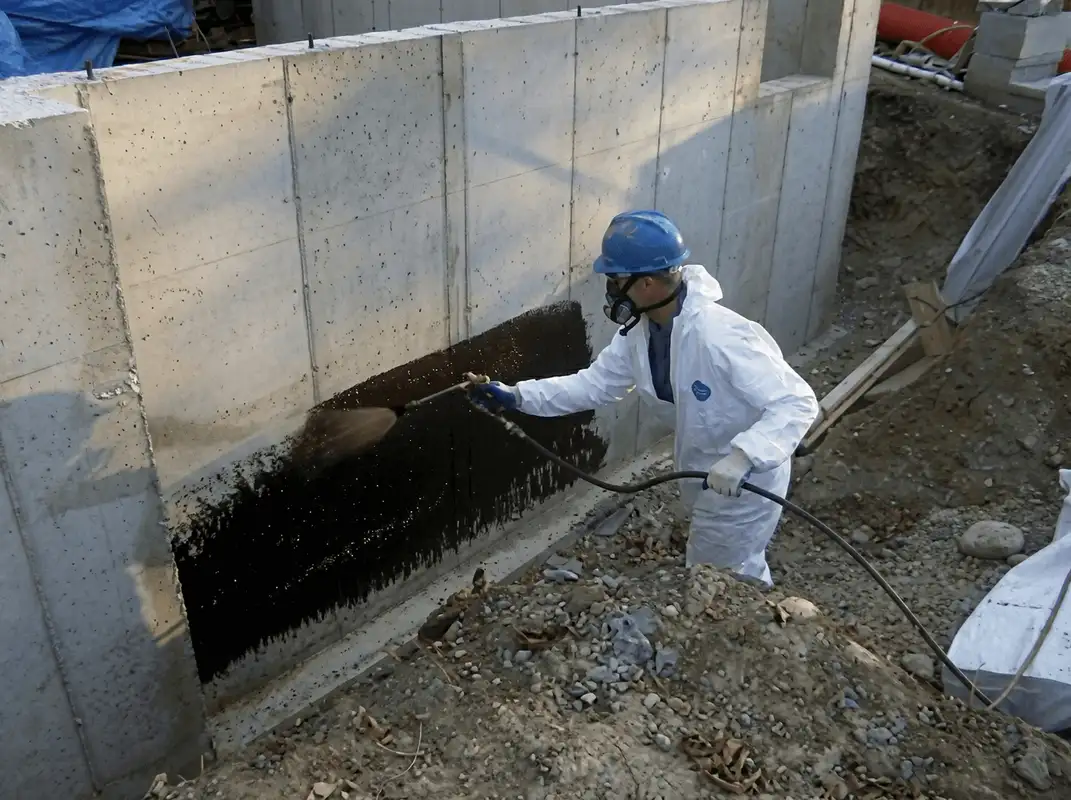 Professional waterproofing the exterior walls of the basement in Riverside, CA