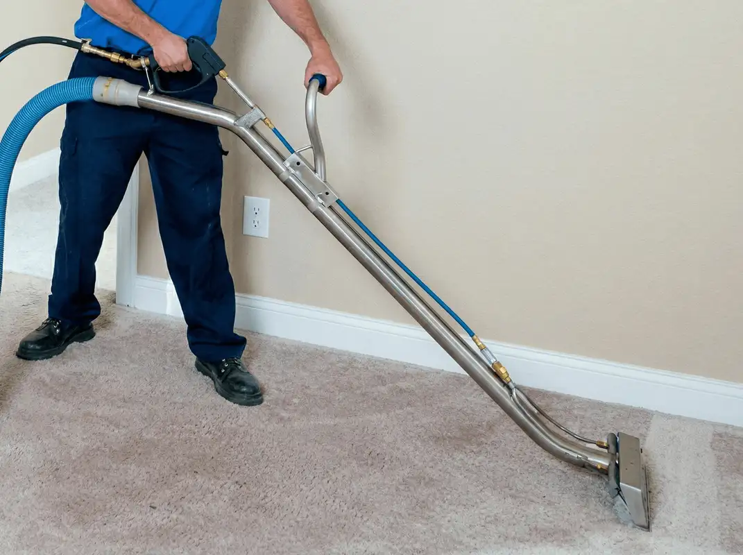 Professional operating a liquid removal machine on a carpeted floor in Riverside, CA